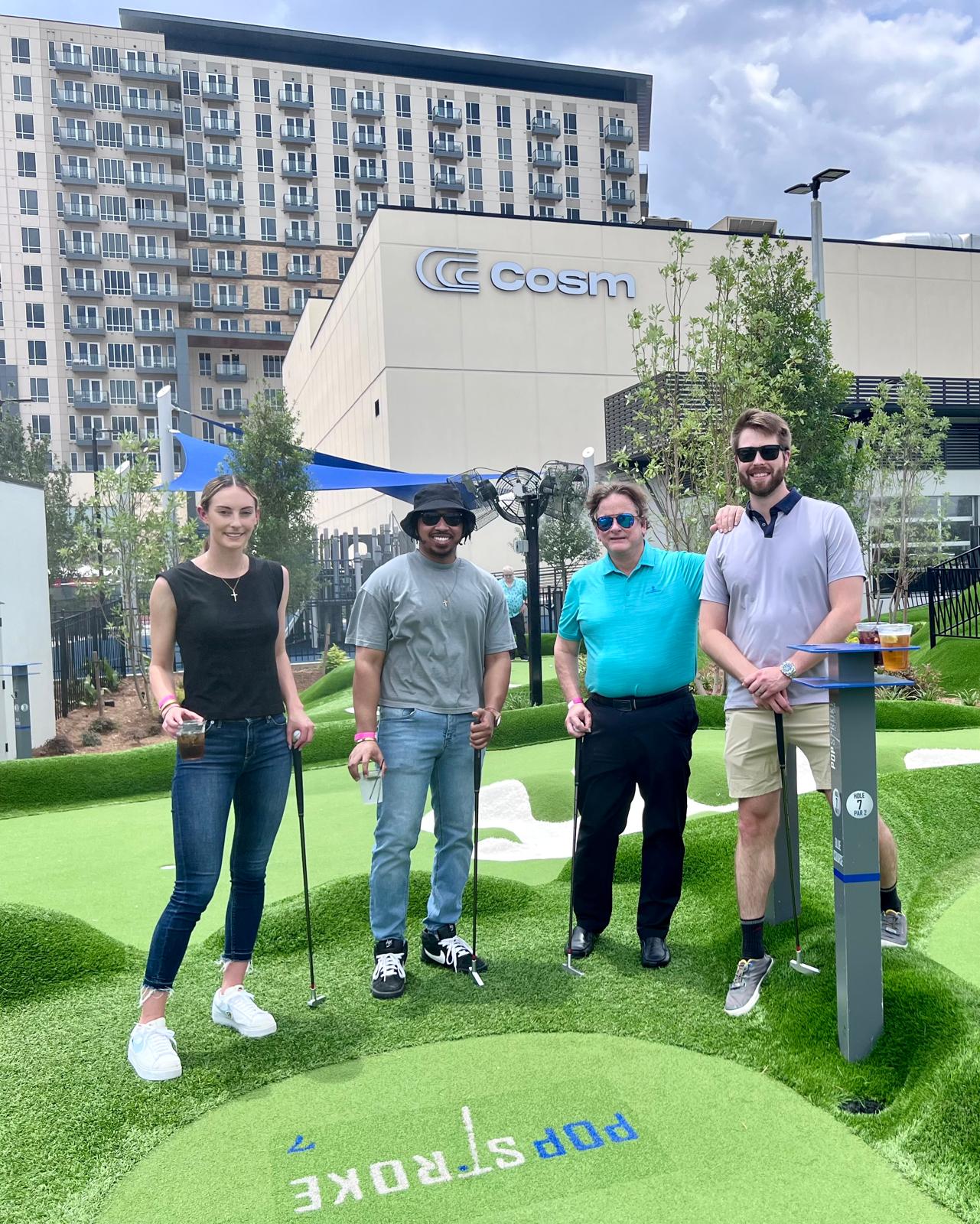 a group of people standing in a golf course